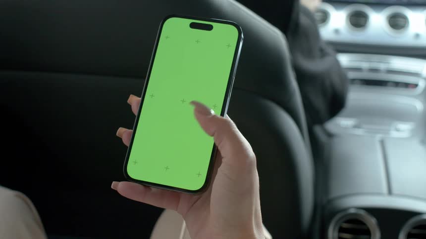 A woman taps the the screen on her phone