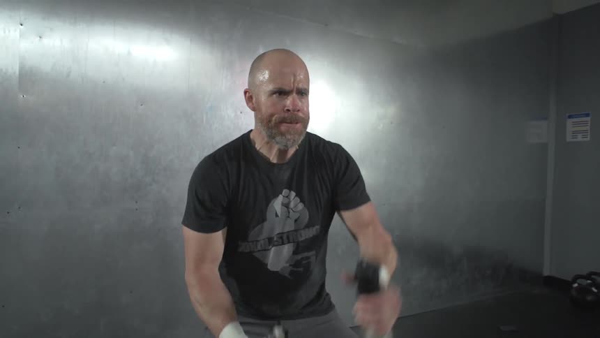 A man exercises with battle ropes