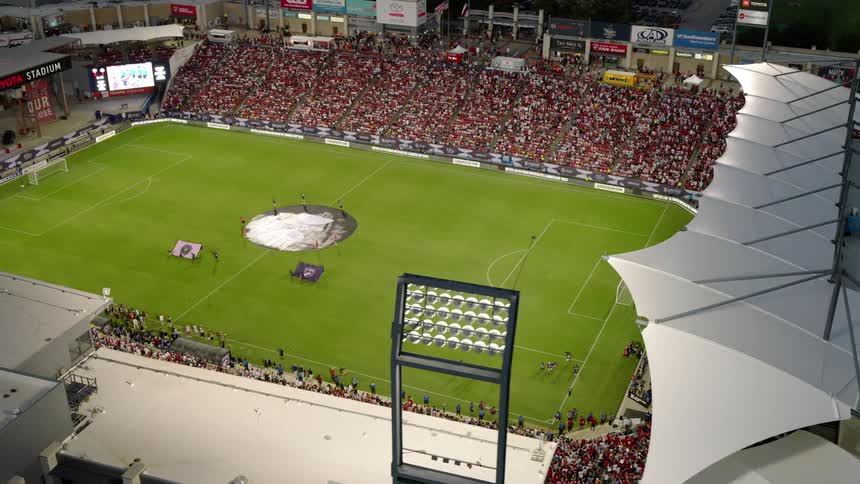 Aerial shot of a soccer stadium with crowds of fans