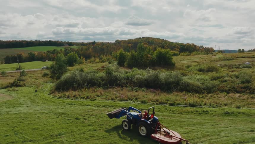 A clip of a tractor moving on a farm land