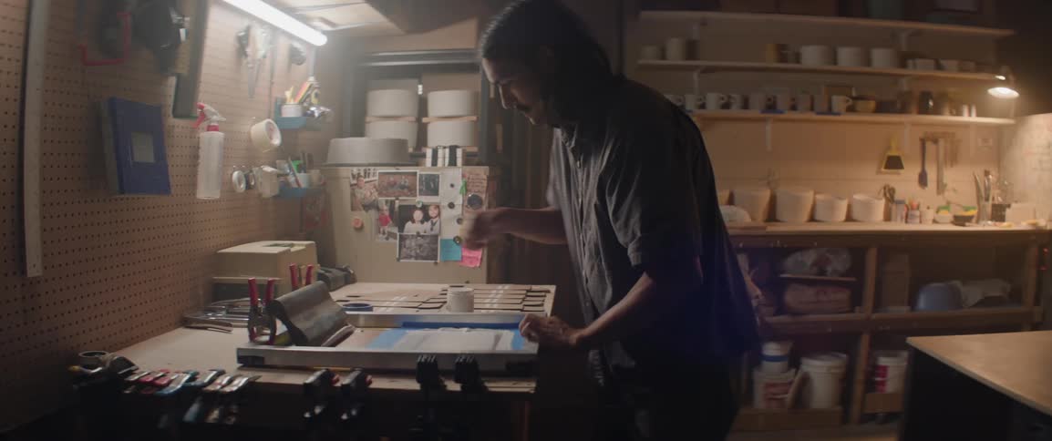 Designer in his workshop screen printing onto materials