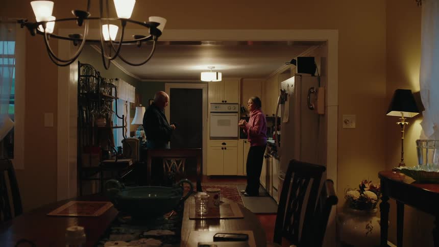 Woman and a man talking in the kitchen