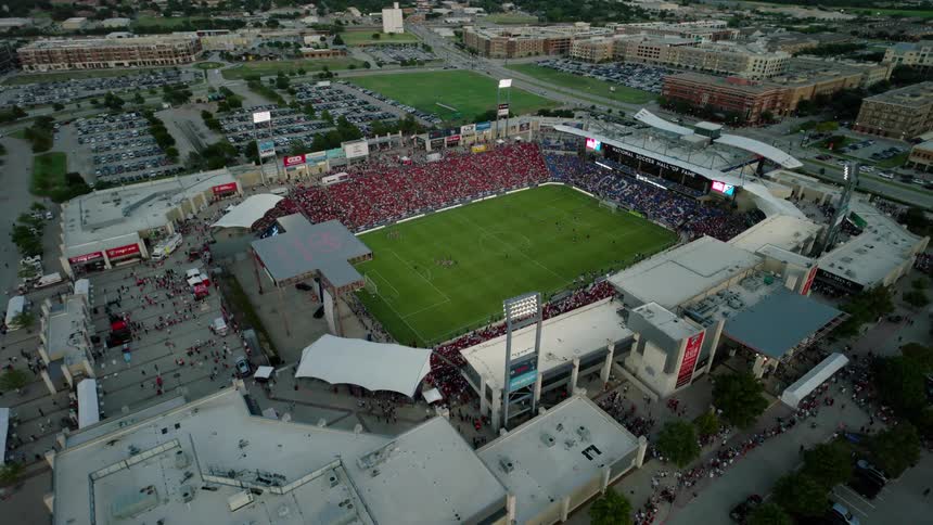 An aerial clip of a stadium in a city