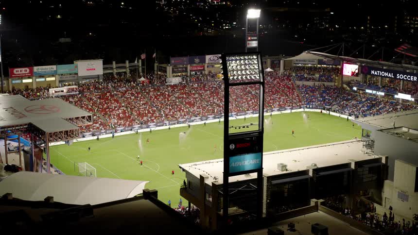Crowd of people in a sports stadium at night