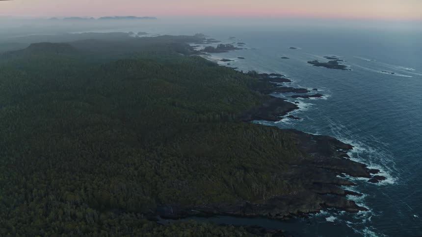 Aerial panorama of a peninsula surrounded by the sea under a purple sunset