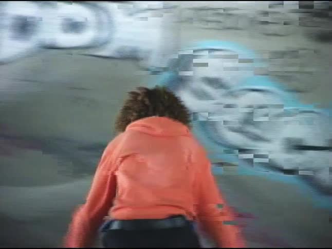 A teenager is doing tricks on his skateboard