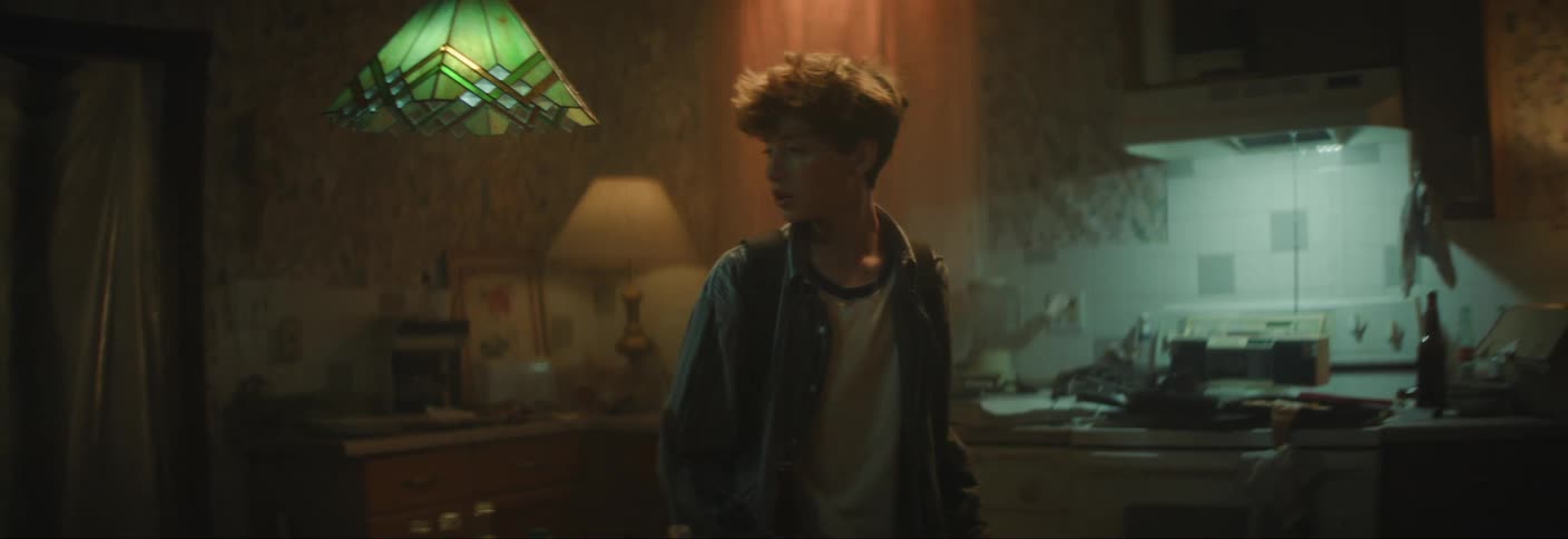 A teenager sneaks through the house and tries to flee through a door