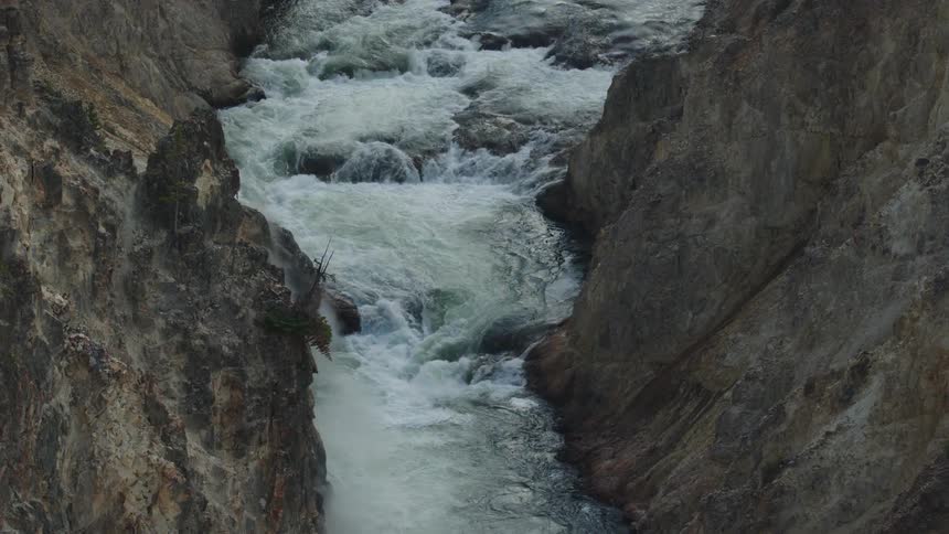 Water rapids of a river rush through a canyon