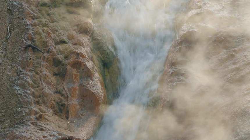 Water cascades down between some rocks