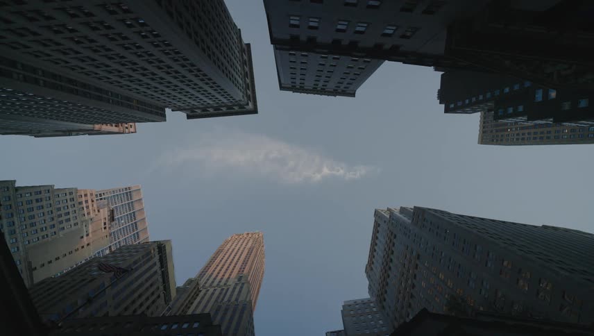 Several commercial skyscraper buildings seen from below against the blue sky