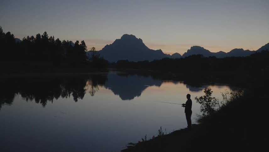 A clip of a man fishing at the river