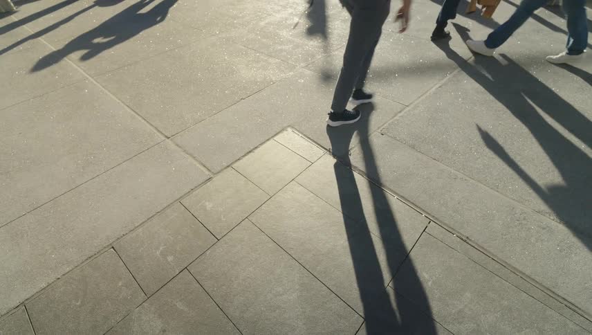 People walking on an outdoor sidewalk