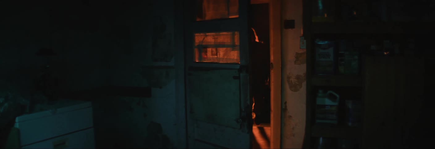 A man slams the door open to enter as a teenager runs away in fear