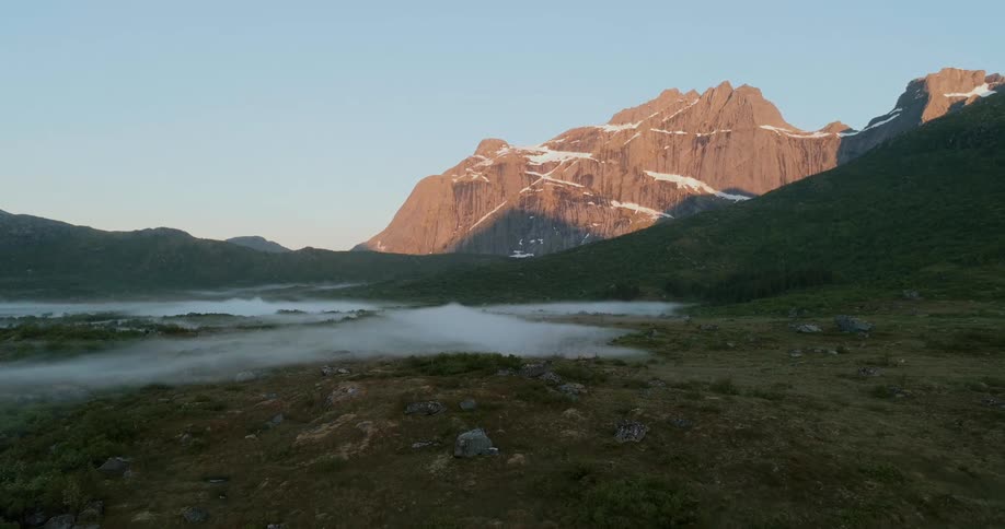 Natural landscape with fog and mountains in the background with snow