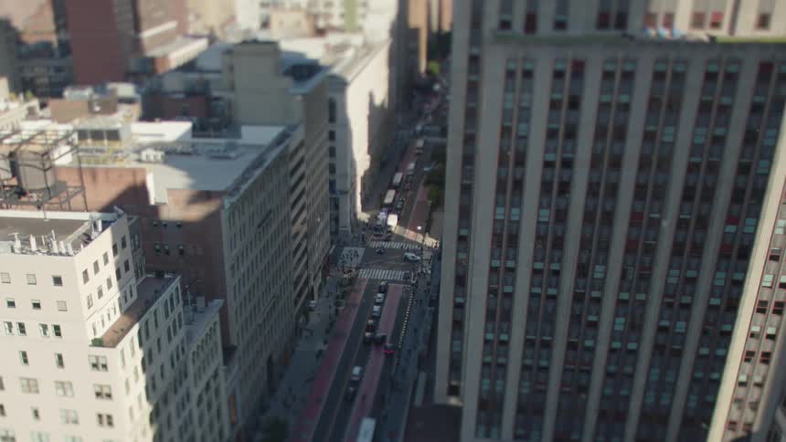Aerial view of buildings in a metropolis and intersections with vehicle traffic