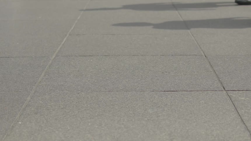 Pedestrians walk on the sidewalk