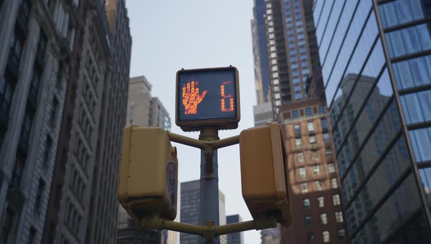 A crosswalk signal changes from dont walk to walk and back to dont walk