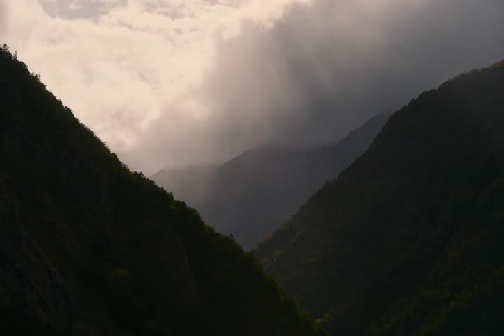 Heavy clouds put the mountains in shade
