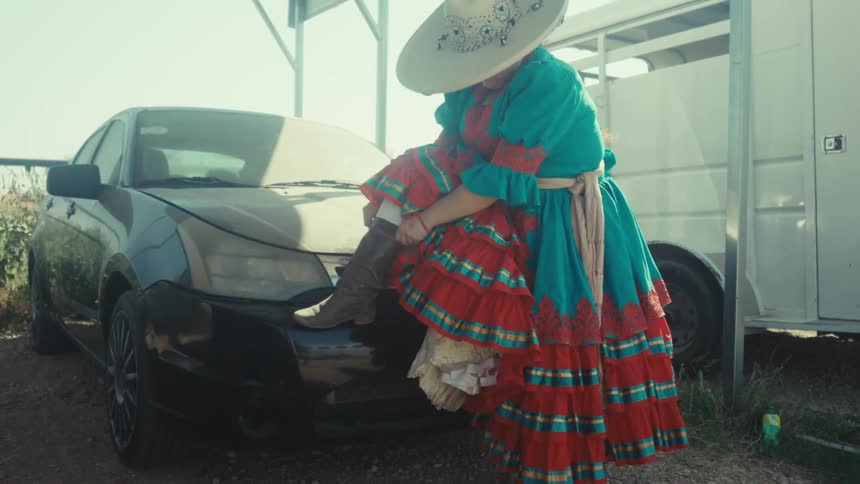 Escaramuza dresses for her performance at a rodeo