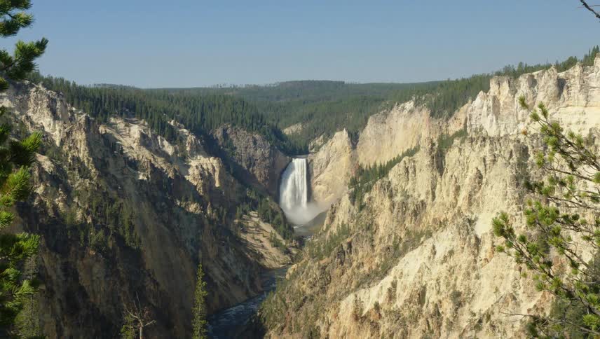 Aerial of a waterfall hidden in the canyons rapidly flowing
