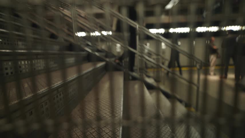 Passengers walk down the stairs of a station to wait for public transportation