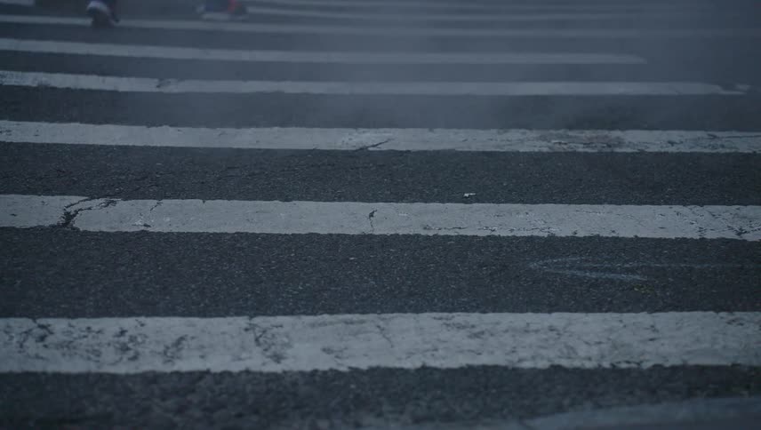 People cross the zebra crossing on the road