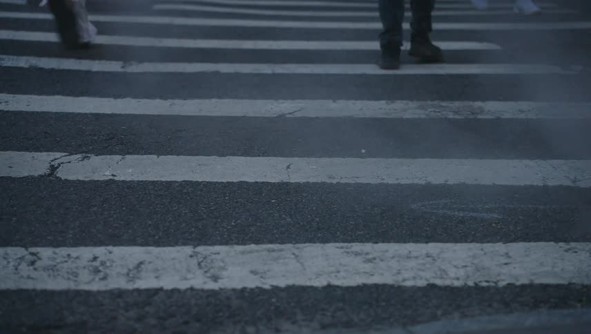 Pedestrian crossing with a vehicle passing and then people walking