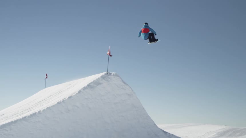 Person snowboarding off a high jump