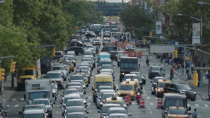 A busy city street with vehicles of all shapes and sizes bumper to bumper creating a gridlock of traffic