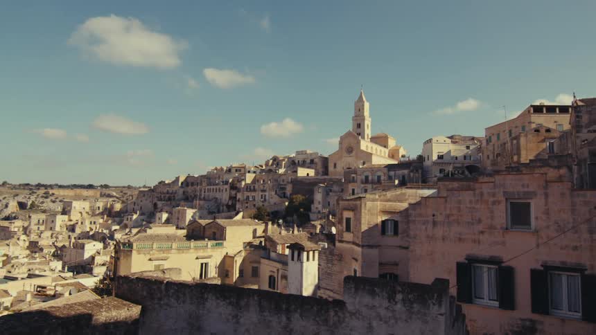 A run down neighborhood in a third world country is shown with all of the houses crammed together