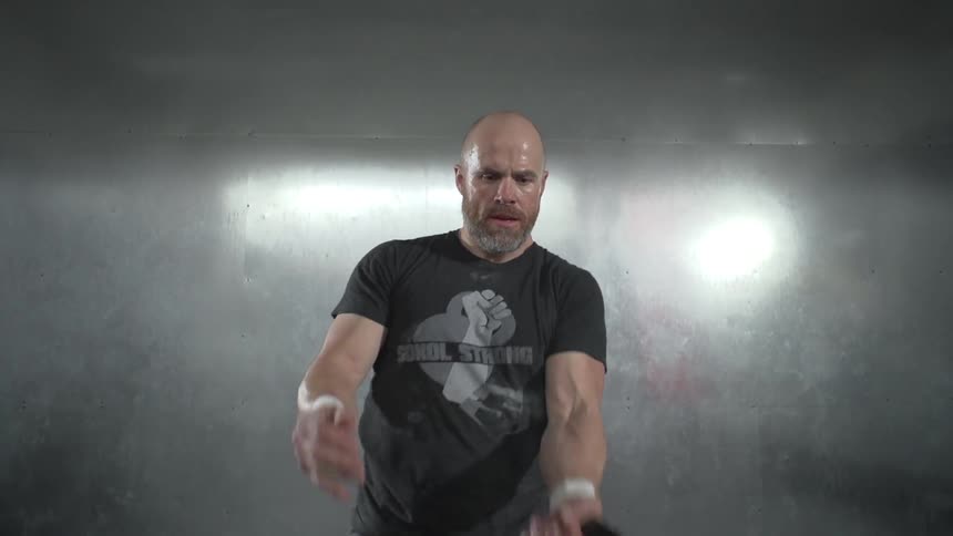Man tossing and catching a kettlebell