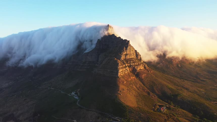 Heavy clouds roll over the mountain peak