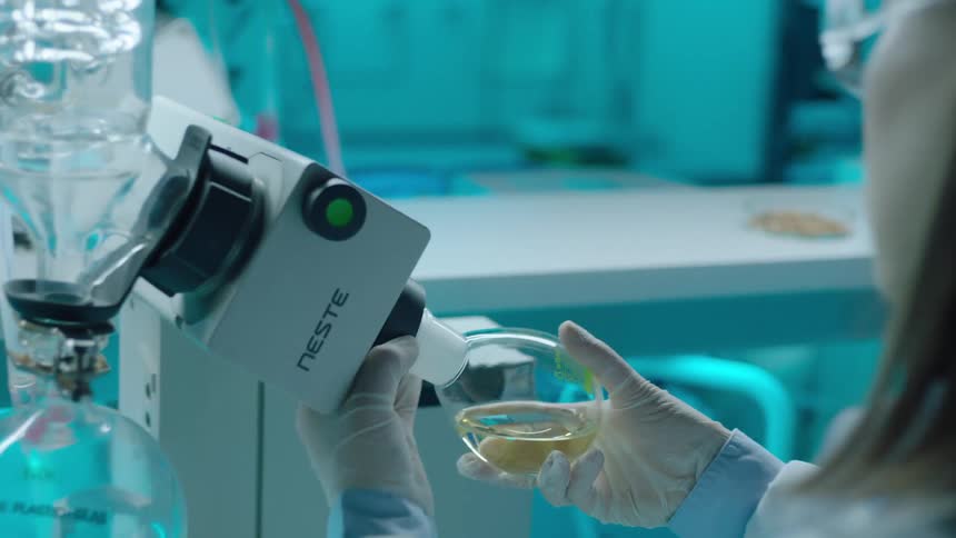 Woman holding a test tube with liquid in a laboratory