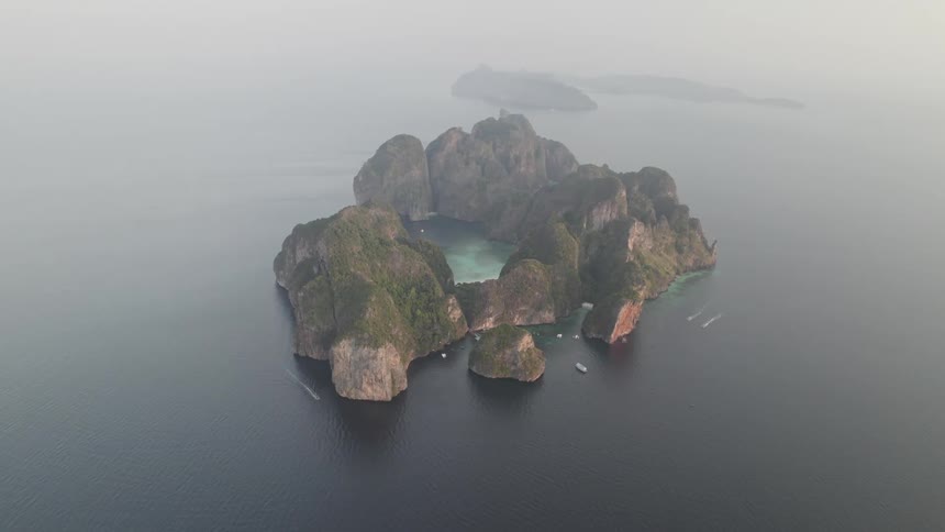 Aerial view of an island surrounded by sea and boats