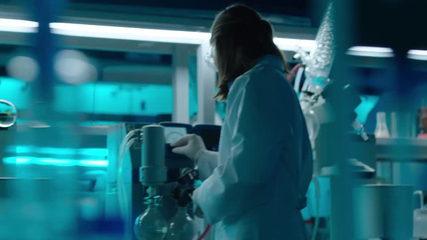 Woman working in a laboratory with equipment and test tubes