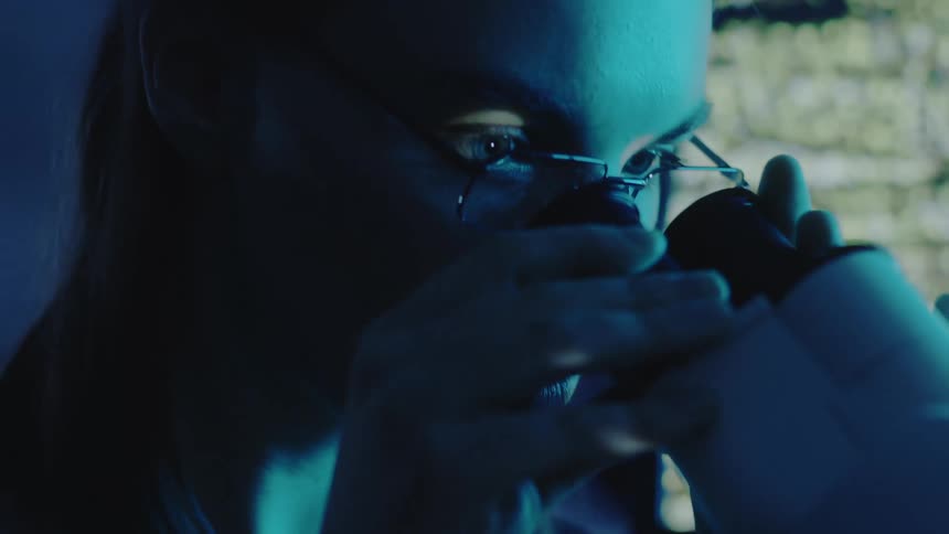 A scientist is using a microscope