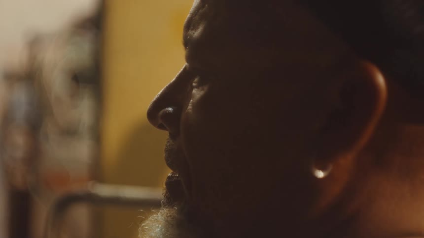 A man is in a room and starts talking