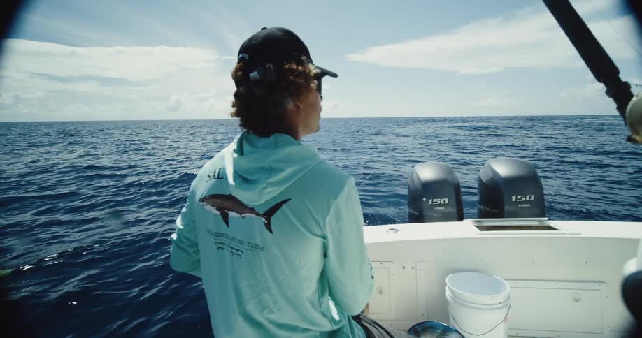 Fisherman sitting on a speedboat in the middle of the sea