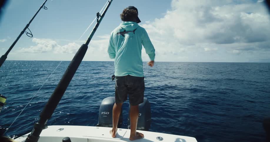 A man is winding up the fishing line