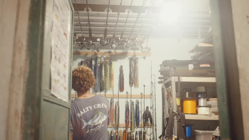 Man in a room with fishing equipment