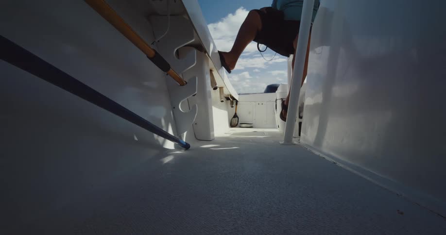 Low angle view of a person boarding a white boat
