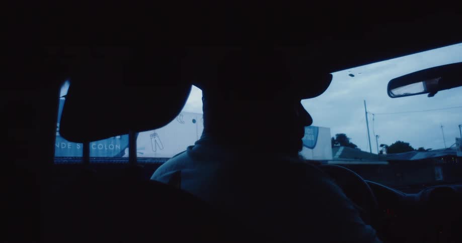 Silhouette of two people sitting inside a car talking