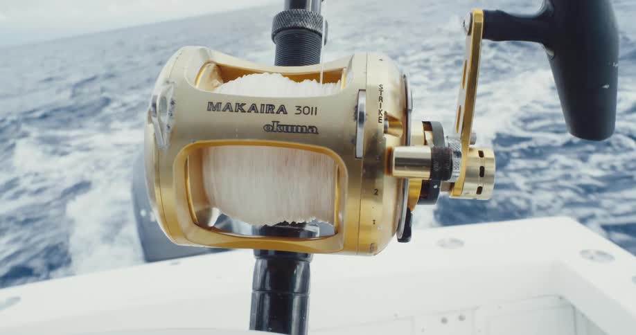 Close up of a fishing rod on a boat moving through the sea