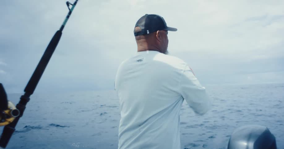 Two men in a boat on the ocean fishing