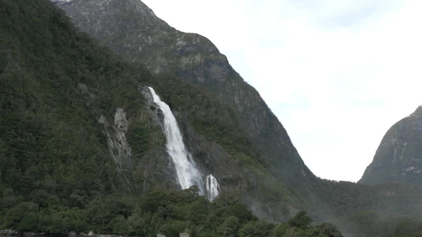 View of a waterfall on the side of a mountain