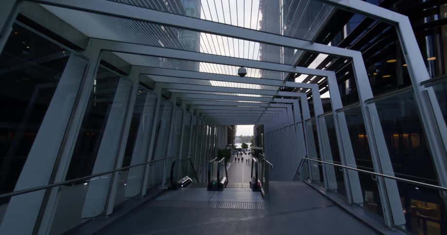 Modern hallway with an escalator in the background and skyscrapers around