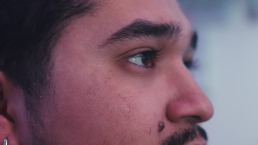 A man is blinking as he watches something
