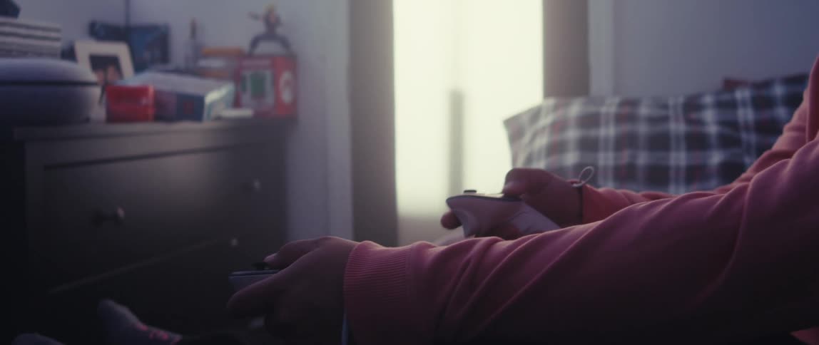 Man sitting in a room interacting with a vr headset