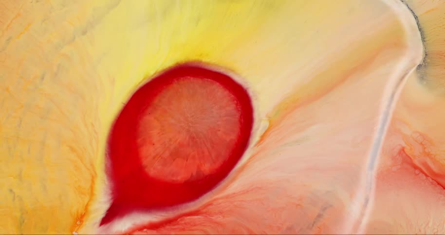 Extreme close up on a reddish liquid succumbing