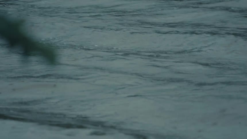 Ripples of water moving on the surface of dark blue water